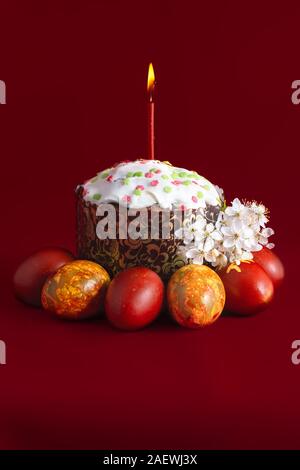 Traditional easter cake kulich and eggs burning candle Stock Photo