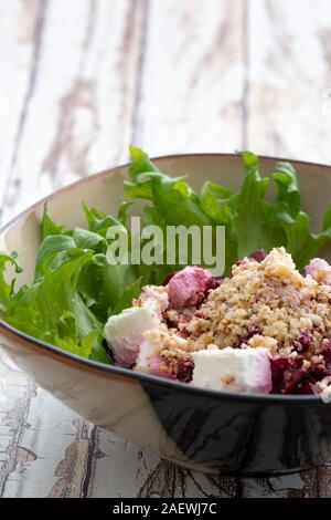 Beetroot salad with oil and nuts in white bowl. Selective focus Stock Photo - Alamy