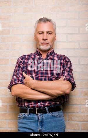 Confident gray aged man crossing his arms Stock Photo