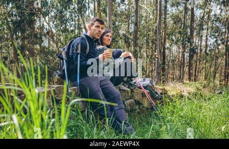 Couple pausing while doing trekking Stock Photo