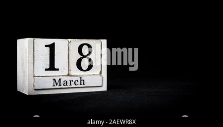 March 18th, Eighteenth of March, Day 18 of month March - white calendar blocks on black textured background with empty space for text Stock Photo