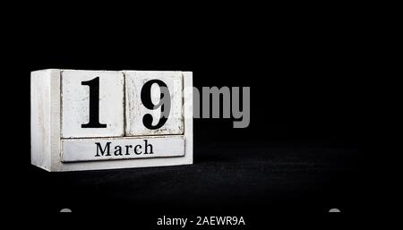 March 19th, Nineteenth of March, Day 19 of month March - white calendar blocks on black textured background with empty space for text Stock Photo