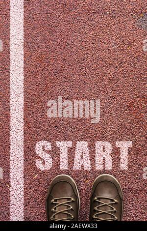 selfie, feet in shoes with drawn word start and start line, top view Stock Photo