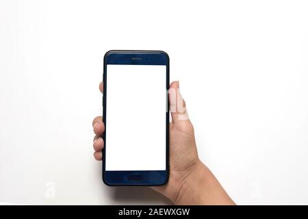 woman holds smartphone in her left hand on a white background with copyspace Stock Photo