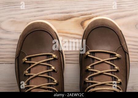 selfie, new brown leather shoes top view on a wooden background Stock Photo
