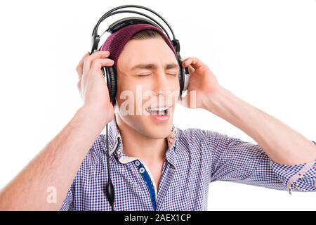 Portrait of man in cap and headphones listening music and singing Stock Photo