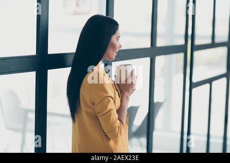 Profile side view portrait of her she nice attractive charming lovely pretty brunet lady drinking fresh aromatic hot cacao latte in modern style light Stock Photo