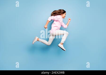 Full length body size photo of cheerful side profile positive crazy excited casual preteen wearing pink pants trousers footwear hurrying for discount Stock Photo