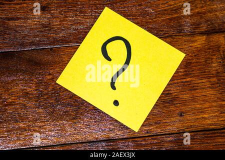 Writing on colorful sticky note a question mark? Question mark on paper. Stock Photo
