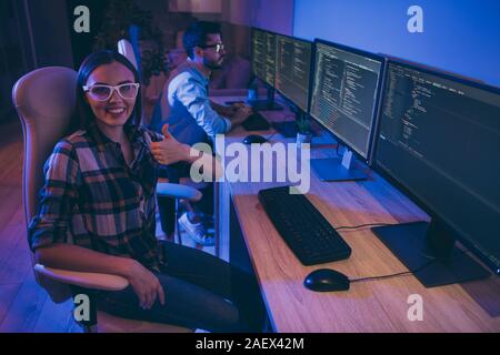 Profile photo of it specialist two guy lady business people working together night raising thumb up recommend vacant place company occupation sitting Stock Photo