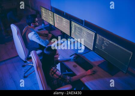 High angle above view photo of it specialist two guy lady business people work late night together writing code for deadline skilled professionals Stock Photo