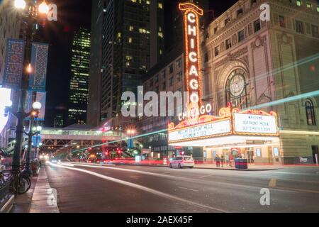 Chicago, IL - Circa 2019: Chicago landmark theatre famous venue in downtown. Night time exterior establishing shot long exposure of traffic light trai Stock Photo