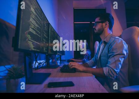 Profile photo of it specialist two people guy lady business people night hard-working together sitting chairs monitors testing system secure code Stock Photo