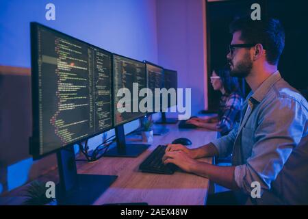 Profile photo of it specialist two people guy lady business people night hard-working together sitting chairs monitors testing system secure code Stock Photo