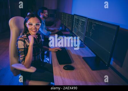 Profile photo of it specialist two guy lady business people love working late together at night watch monitors writing startup interface back-end code Stock Photo