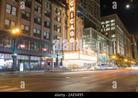 Chicago, IL - Circa 2019: Chicago landmark theatre famous venue in downtown. Night time exterior establishing shot long exposure of traffic light trai Stock Photo