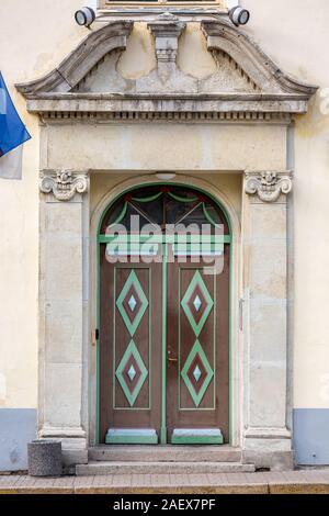 Wooden beautifully colored and decorated old door in Tallinn, Estonia. Stock Photo