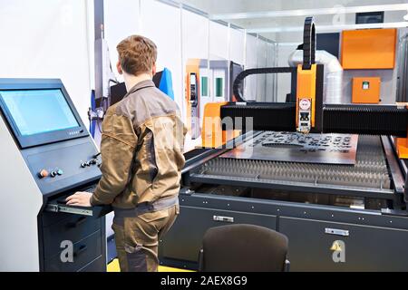 Worker operator laser cutting complex for metal Stock Photo