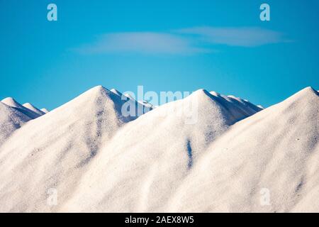 Mounds of sea salt beside the salt pans Bras del Port in Santa Pola, Spain. Stock Photo