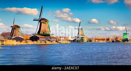 Authentic Zaandam mills on the water channel in Zaanstad willage. Zaanse Schans Windmills and famous Netherlands canals. Stock Photo