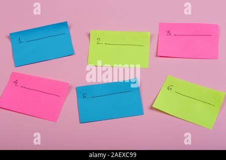 Plan of the week on colored blank stickers on pink background Stock Photo