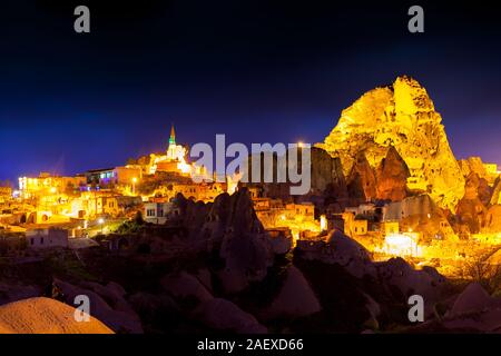 Night scene of the Uchisar Castle in Cappadocia. Illuminated view of famous Uchisar village, district of Nevsehir Province in the Central Anatolia Reg Stock Photo