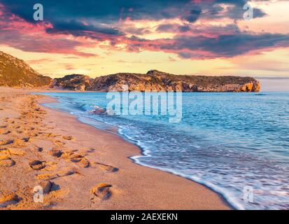 Footprints in the sand on the famous Turkish beach Patara. Colorful sunset in the Turkey, District of Kas, Antalya Province, Asia. Artistic style post Stock Photo