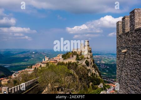 View of the Guaita fortress on Monte Titano, mountainous landscape in the distance Stock Photo