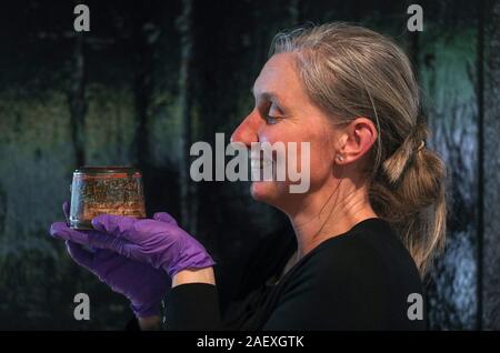 Victoria Ingles, senior curator at the National Museum of the Royal Navy, holds a 120 year old Christmas pudding, which is thought to be the oldest in the world and is the last surviving Christmas pudding from a batch of 1,000 sent to naval personnel serving on the front during the Boer War. Stock Photo