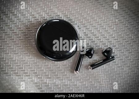 Belgrade, Serbia – November 18th, 2019: Huawei FreeBuds 3 headphones in black color Stock Photo