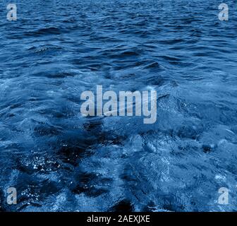 Surface ocean blue water background. Natural water paradise. Ocean nature depth and tranquility. Stock Photo