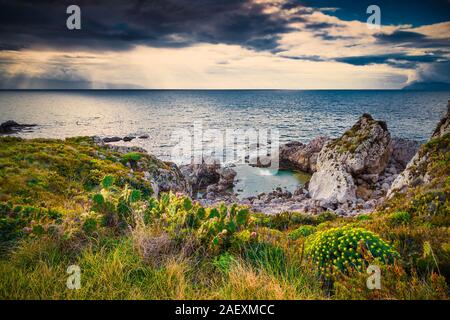 Dramatic spring sunset on the the cape Milazzo, nature reserve Piscina di Venere, Sicily, Italy, Tyrrhenian sea, Europe. Stock Photo