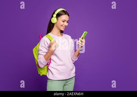 Photo of cheerful cute sweet pretty girlfriend reading received message while listening to her favorite pop musician going to school with music rhythm Stock Photo