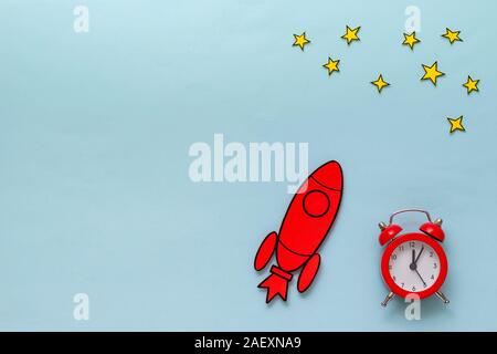 Red cartoon rocket with alarm clock and stars Stock Photo