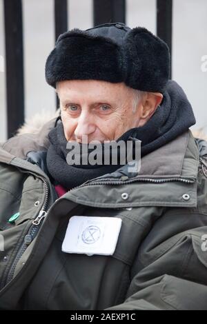 London, UK, 11 December 2019: Extinction Rebellion activist Professor Peter Cole on the 24th day of his hunger strike sits outside Conservative Party headquarters in London, waiting for someone from the Conservative Party to come out and discuss climate crisis issues with him. Anna Watson/Alamy Live News Stock Photo