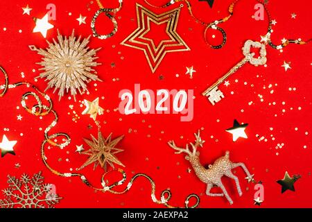 2020 on red background with sparkles. Flat lay style. Stock Photo