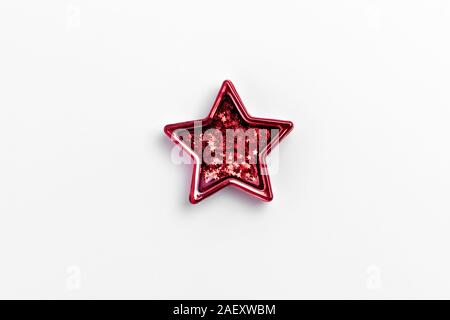 Christmas five pointed red star on white background. Christmas glittery decoration. Holiday concept Stock Photo