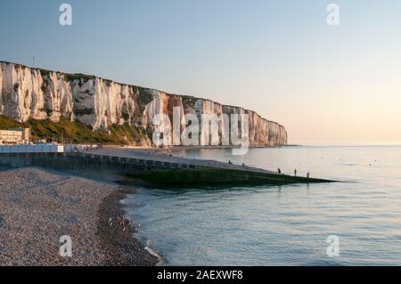 White cliffs, pebble beach with tourists and fishermen on a Summer evening, Le Treport town, Seine-Maritime (76), Normandy, France Stock Photo