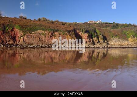 Reflections in Broadsands beach at low tide. Stock Photo
