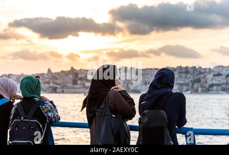 Female muslim tourists watching the sunset at the Corniche park at Uskudar, Istanbul, Turkey, on the Anatolian shore of the Bosphorus. Stock Photo