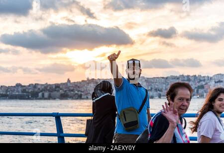 Tourists watching the sunset at the Corniche park at Uskudar, Istanbul, Turkey, on the Anatolian shore of the Bosphorus. Stock Photo