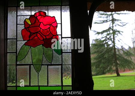 Stained glass window in the thatched summer house, Trelissick Gardens, Feock, Cornwall Stock Photo