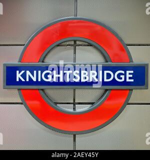 Knightsbridge tube station. Roundel platform sign for the Piccadilly Line Underground station in the heart of London's upmarket shopping district. Stock Photo