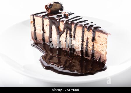 Chocolate cake with chocolate sauce, close up on white background Stock Photo