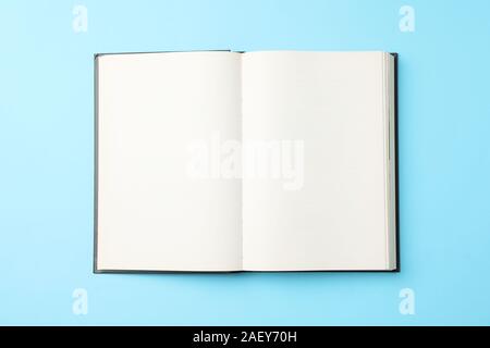 Opened empty book on blue background, top view Stock Photo