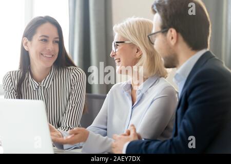 Diverse businesspeople laugh working together in office Stock Photo
