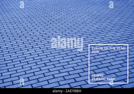 Photo of the site from the old paving slab with small defects and cracks. Phantom classic blue color tone. Stock Photo
