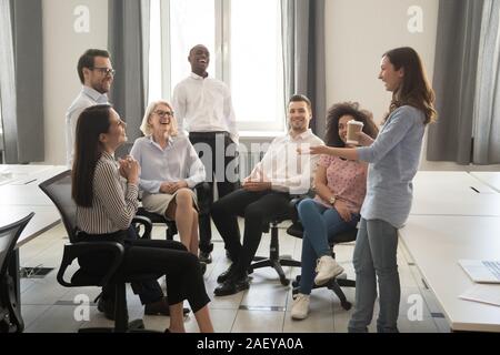 Smiling diverse colleagues have fun talking at coffee break Stock Photo