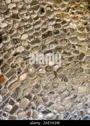 Ancient floor made of round pebbles from the Middle Ages. Flooring, made of selected and hand-sorted stones in mortar, with intensive signs of wear. Stock Photo