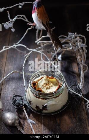 Chocolate yogurt in a glass jar.Delicious dessert on a winter morning.Healthy food and sweets Stock Photo
